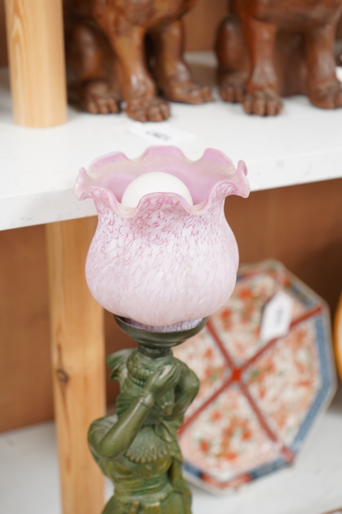 A composite lamp in the form of a female figure, with pink fluted glass shade, 50cm high overall